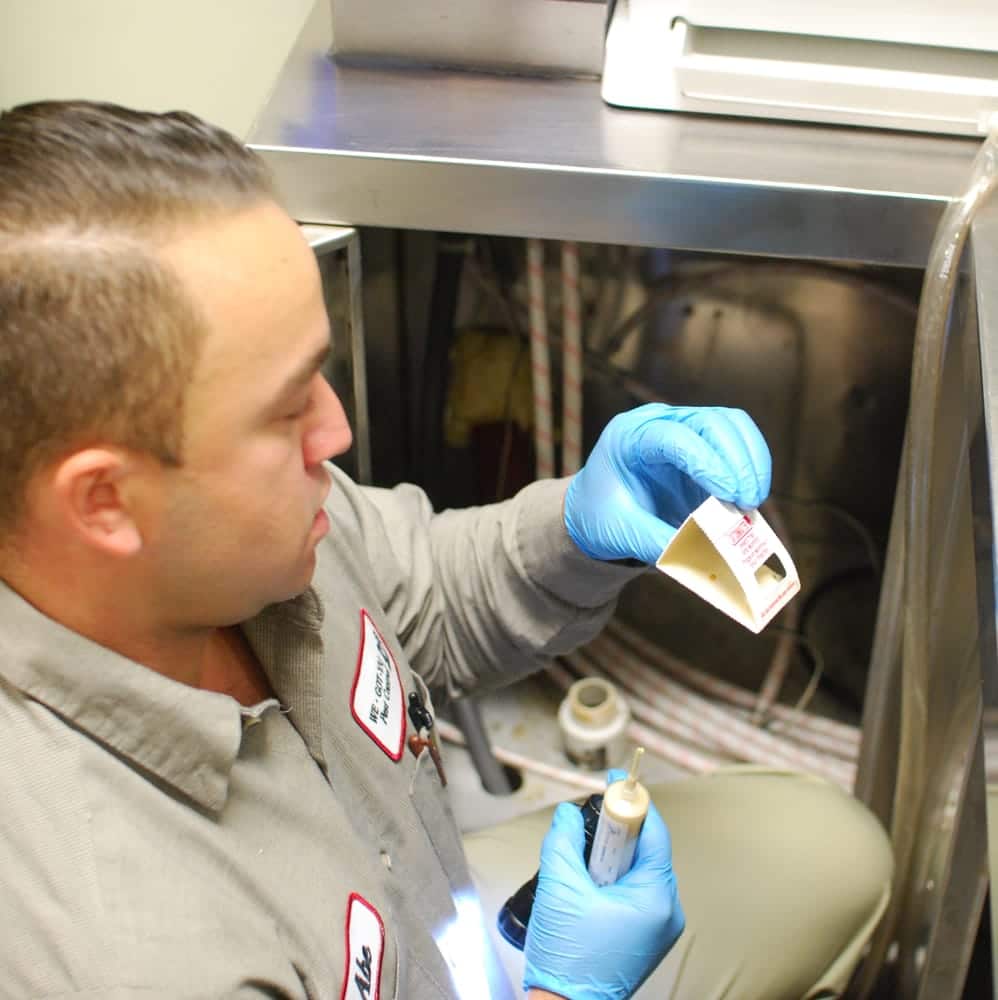 pest control specialist setting cockroach traps